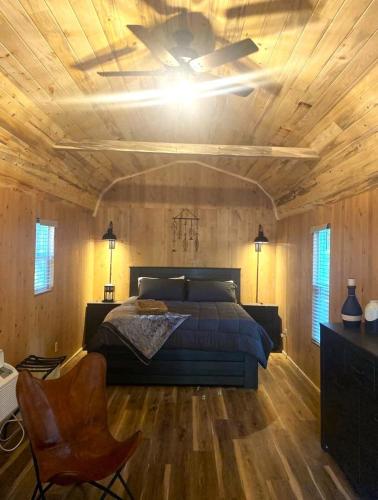 a bedroom with a bed and a ceiling fan at Gold Creek Cabin 3 - Sleeps up to 4 in O'Brien