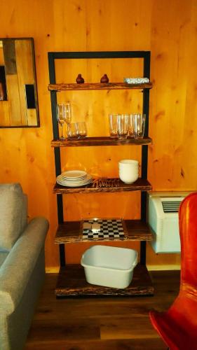 a kitchen with a shelf with plates and glasses at Summer Trail Cabin 5 - Sleeps up to 4 in O'Brien