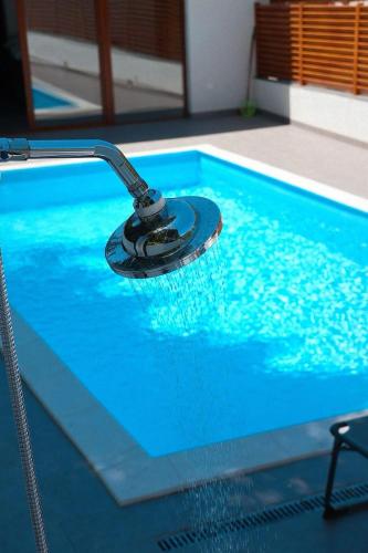 a swimming pool with a faucet in the water at Zen Oaza in Konjic