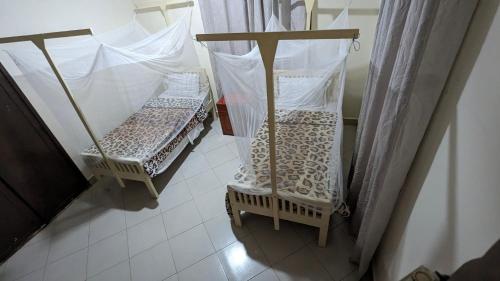 Кровать или кровати в номере JACARANDA HOMESTAY