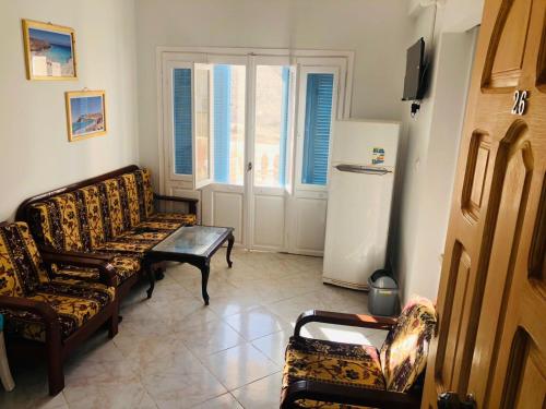 a living room with two couches and a refrigerator at La Perla Di Agiba لؤلؤة عجيبة in Marsa Matruh