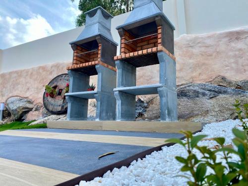 a pair of bird feeders in a garden at Casa das Laixas in Laxe