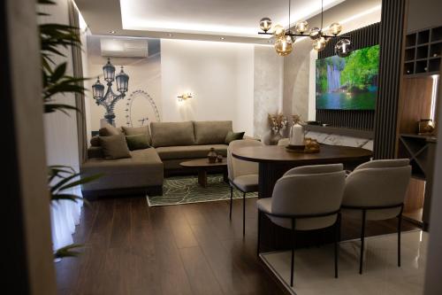 a living room with a couch and a table at Spa Prestige Apartman Brcko in Brčko