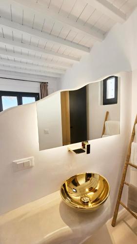 a bathroom with a gold sink on the floor at ELLI TROPiCAL LUXURY SUITES SUNSET-INFINITY POOL- SEA SIDE-NEAR CENTER PARKING in Mikonos