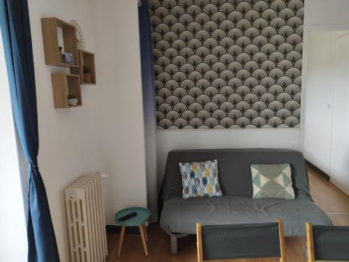 a living room with a couch and a chair at L'Albatros in Perros-Guirec
