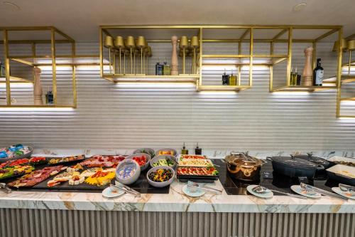 a buffet line with many different types of food at Crowne Plaza Constanta - Mamaia Beach by IHG in Mamaia
