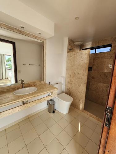 a bathroom with a sink and a shower and a toilet at Pousada Dreamland Buzios in Búzios