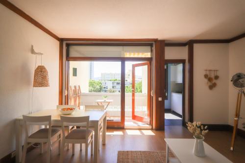 a kitchen and dining room with a table and chairs at Troia beach apartment by Dias de Sol in Troia