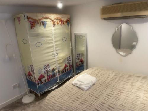 a bedroom with a bed and a large mirror at Room in Cheshunt in Cheshunt