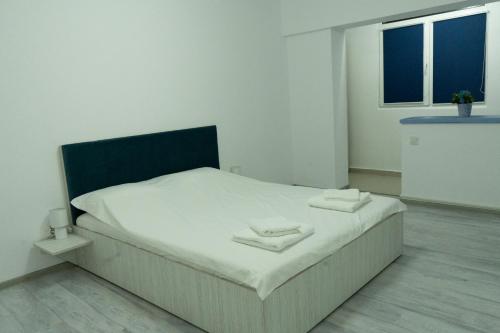 a bedroom with a bed with two towels on it at M & M Studio in Jurilovca