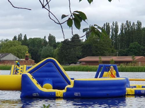a group of inflatable slides in the water at Billing Aquadrome - Alberta Caravan 2 Bedroom Sleep 6 in Northampton