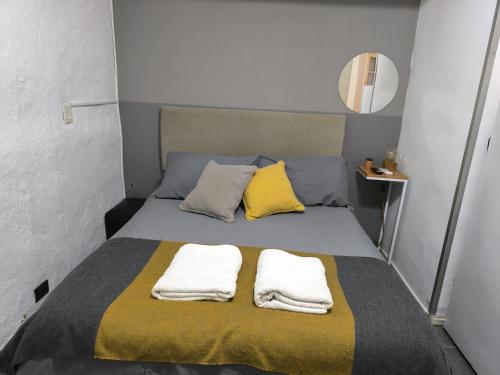 a bedroom with a bed with two towels on it at Monoambiente Gavilan in Buenos Aires