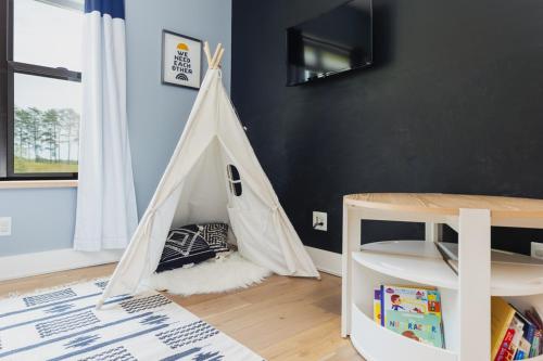 a childs playroom with a play tent in a room at Oasis Near Charlottesville With Pool, Grill in Zion Crossroads
