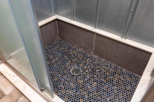 a shower with a tile floor in a shower stall at Oasis Near Charlottesville With Pool, Grill in Zion Crossroads