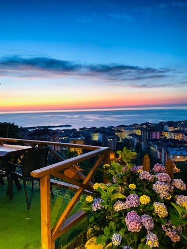 a view of the sunset from a balcony with flowers at Lavinya Suit Bungalov in Rize