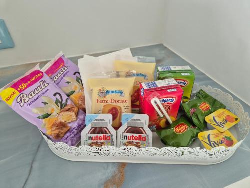 a basket filled with food and snacks on a table at Albicocche house Catania in Catania