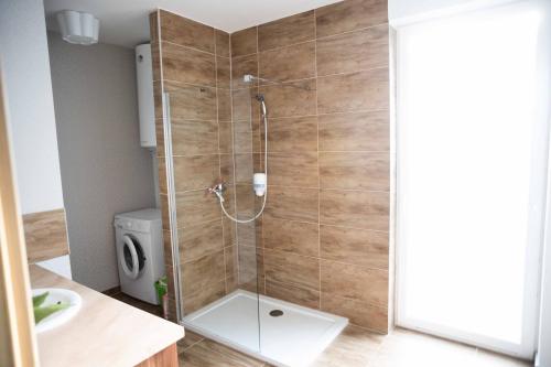 a shower with a glass door in a bathroom at House of Kenese-Völgye in Balatonkenese