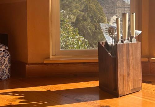a wooden knife block sitting in front of a window at Sunshine House - Nestled In Page Springs in Cottonwood