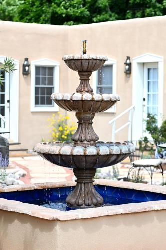 a fountain in the middle of a yard at Dos Hermanas Compound 7 Casitas Downtown in Santa Fe