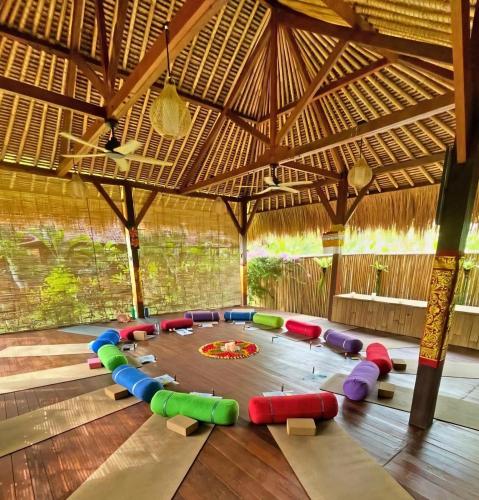 a large room with a play room with a table at Island Garden Huts Lembongan in Nusa Lembongan