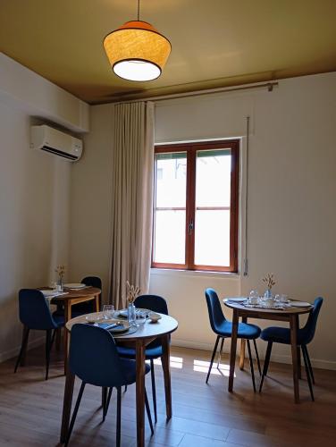 a dining room with two tables and chairs and a window at Letizia B&B in Crotone