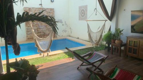 a living room with a swimming pool with two hammocks at Casa Intensamente in Jesús María