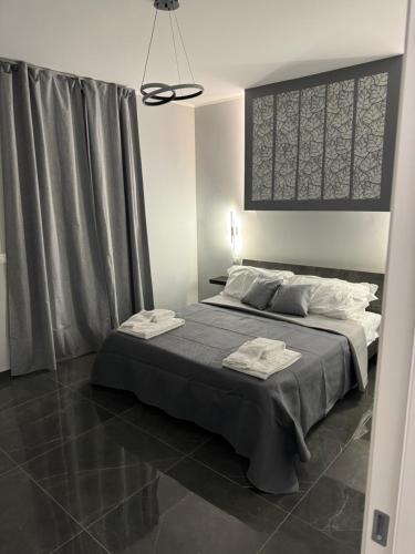 a bedroom with a large bed in a room at Reale Guest House in Mascalucia