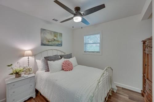 a bedroom with a white bed and a ceiling fan at Lakefront, Private Dock, Spectacular Views in Bridgeport