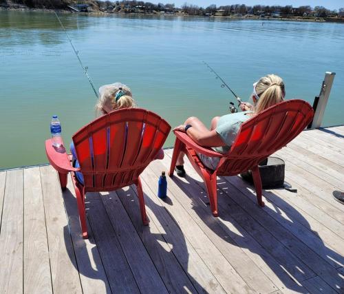 two children sitting in chairs on a dock with fishing at Lakefront, Private Dock, Spectacular Views in Bridgeport