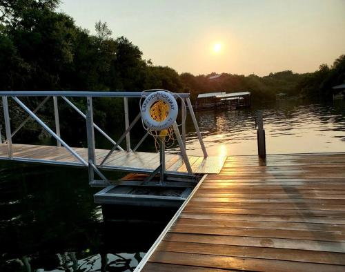 a chair sitting on a dock on a lake at Lakefront, Private Dock, Spectacular Views in Bridgeport