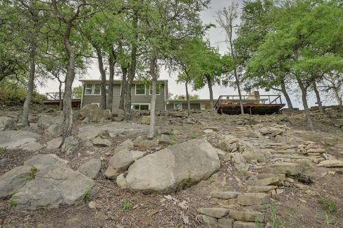 a house with a bunch of rocks and trees at Lakefront, Private Dock, Spectacular Views in Bridgeport