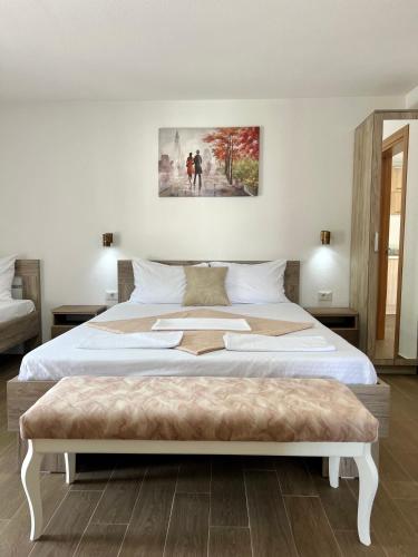 a bedroom with a large bed with a white bedspread at Apartmani Juković in Ulcinj