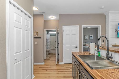 a kitchen with a sink and a white door at Completely Renovated Queen Suite with LED Fireplace! The Fairways 5E in Myrtle Beach