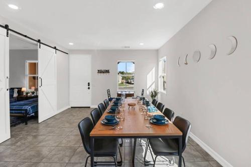 a dining room with a long table and chairs at Paradise Coachella NEW Salt Water Pool & Landcape in Coachella