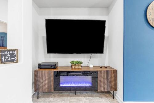 a living room with a tv and a fireplace at Paradise Coachella NEW Salt Water Pool & Landcape in Coachella