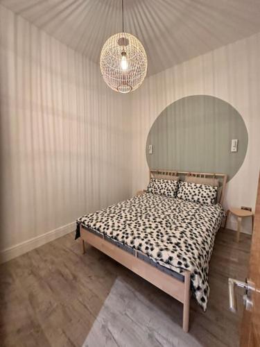 a bedroom with a bed and a chandelier at Urban Oasis 2 bed apartment in Manchester