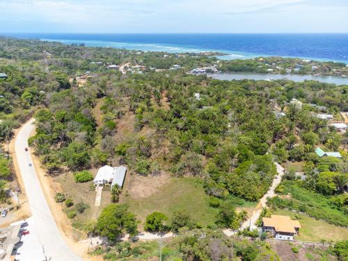 an aerial view of a house on a hill next to the ocean at Wescot Villas Roatan in Roatan