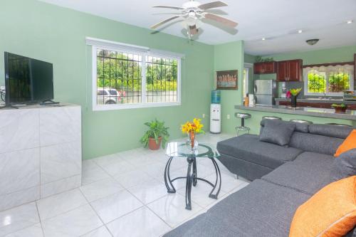 a living room with a couch and a table at Wescot Villas Comfort in Roatan