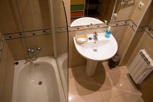 a bathroom with a sink and a bath tub at Apartahotel Rural CollaRubio Luxury in Collado Mediano