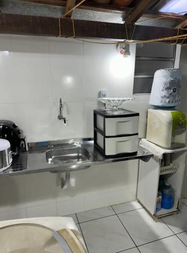 a kitchen with a sink and a counter top at Suíte com entrada independente in Ubajara