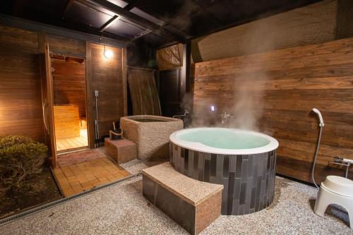 a bathroom with a jacuzzi tub and a shower at Win Village in Sasebo