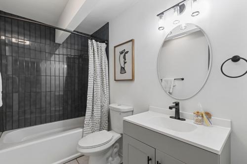 a white bathroom with a sink and a mirror at Cozy Unique 1 bed room with Free parking in Austell