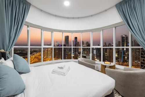 a bedroom with a white bed and a large window at Stunning Panoramic Sea & Marina City Skyline View in Dubai