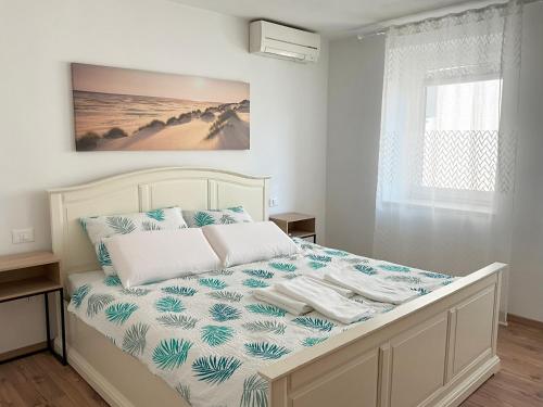 a bedroom with a bed with blue and white sheets at Emica's holiday home in Koper