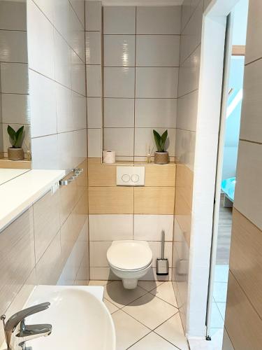 a bathroom with a toilet and a sink at Emica's holiday home in Koper