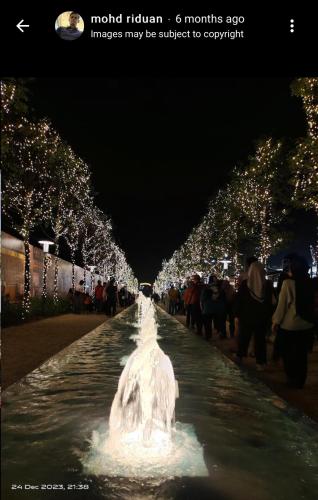 a fountain in the middle of a street at night at Araas Boutique House for Family Stay ONLY in Sungai Buluh