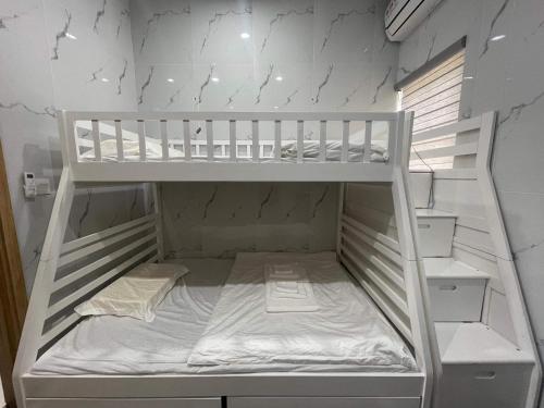 a white bunk bed in a white wall at Holiday Villa Novaworld Phan Thiet in Phan Thiet