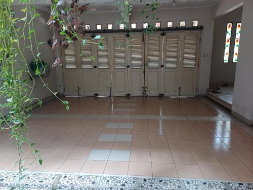 a row of lockers in a room with a tile floor at Puri Nusa Indah,Cozy, Large, Near Bogor City in Kedunghalang
