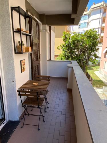 a patio with a table and chairs on a building at Silent Bay Apartments in Sestri Levante