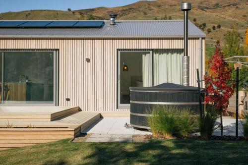 a house with a large window and a porch at Abodo Alpine Eco Villa Spa in Cardrona